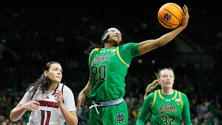 Notre Dame forward Liatu King (20) reaches out for a rebound during a NCAA women's basketball game between No. 3 Notre Dame and No. 25 Louisville at Purcell Pavilion on Sunday, March 2, 2025, in South Bend. Notre Dame forward Liatu King (20) reaches out for a rebound during a NCAA women's basketball game between No. 3 Notre Dame and No. 25 Louisville at Purcell Pavilion on Sunday, March 2, 2025, in South Bend.
