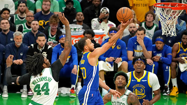 Golden State Warriors guard Stephen Curry (30) shoots the ball against Boston Celtics forward Aaron Nesmith (26) and center Robert Williams III (44) during the first quarter in game six of the 2022 NBA Finals at TD Garden. Mandatory Credit: Kyle Terada-Imagn Images