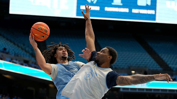 Oct 12, 2024; Chapel Hill, NC, USA;  North Carolina Tar Heels guard Elliot Cadeau (3) shoots as forward Ty Claude (0) defends in the first half at the Dean E. Smith Center. Mandatory Credit: Bob Donnan-Imagn Images