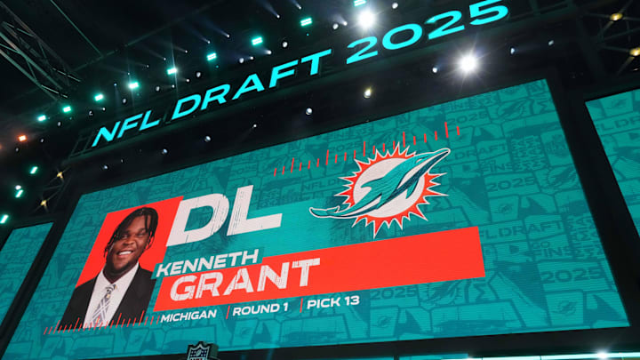 Michigan Wolverines defensive lineman Kenneth Grant is selected as the No. 13 pick by the Miami Dolphins during the NFL Draft at Lambeau Field.