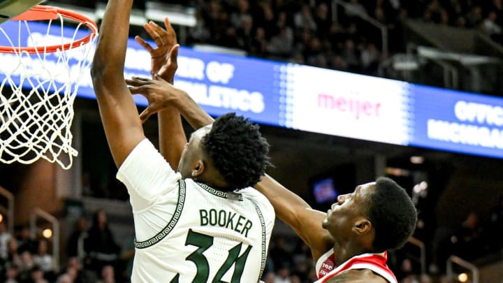 Michigan State's Xavier Booker, left, dunks and is fouled by Ohio State's Scotty Middleton during the second half on Sunday, Feb. 25, 2024, at the Breslin Center in East Lansing. Michigan State's Xavier Booker, left, dunks and is fouled by Ohio State's Scotty Middleton during the second half on Sunday, Feb. 25, 2024, at the Breslin Center in East Lansing.