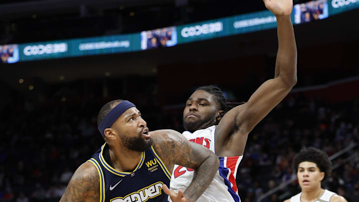 Jan 25, 2022; Detroit, Michigan, USA;  Denver Nuggets center DeMarcus Cousins (4) is defended by Detroit Pistons center Isaiah Stewart (28) in the first half at Little Caesars Arena. Mandatory Credit: Rick Osentoski-Imagn Images