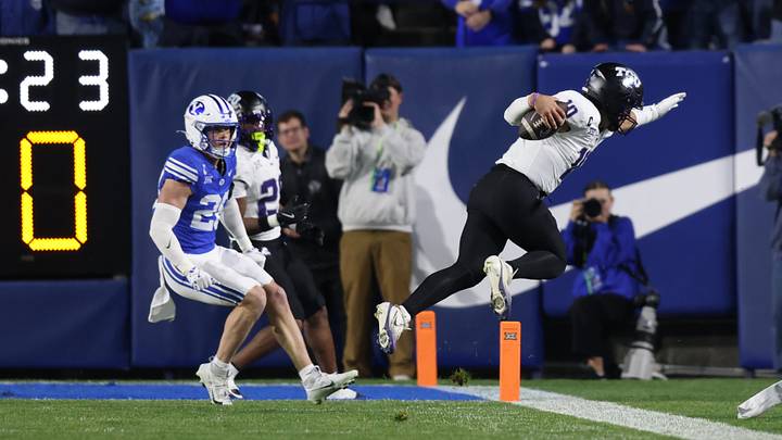 Nov 15, 2025; Provo, Utah, USA; Texas Christian University Horned Frogs quarterback Josh Hoover (10) runs against BYU Cougars cornerback Cannon Devries (20) during the second quarter at LaVell Edwards Stadium. Mandatory Credit: Rob Gray-Imagn Images