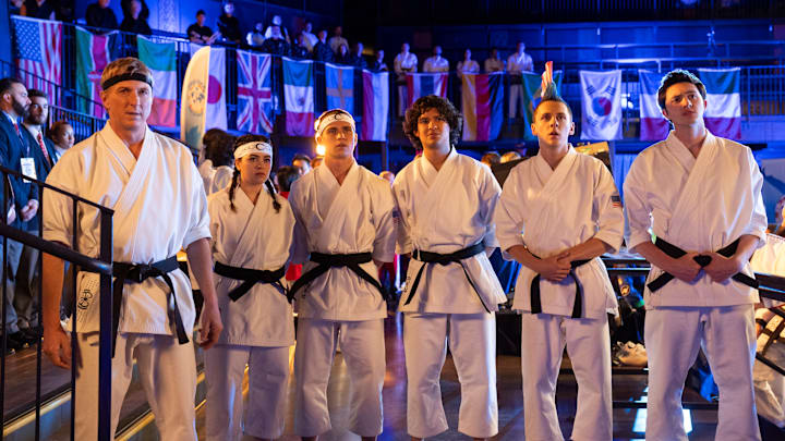 Cobra Kai. (L to R) William Zabka as Johnny Lawrence, Mary Mouser as Samantha LaRusso, Tanner Buchanan as Robby Keene, Xolo Maridueña as Miguel Diaz, Jacob Bertrand as Eli 'Hawk' Moskowitz, Gianni DeCenzo as Demetri in Cobra Kai. Cr. Curtis Bonds Baker/Netflix © 2024