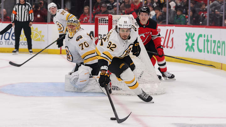 Mar 16, 2026; Newark, New Jersey, USA; Boston Bruins left wing Marat Khusnutdinov (92) plays the puck against the New Jersey Devils during the second period at Prudential Center. Mandatory Credit: Ed Mulholland-Imagn Images