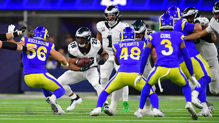Nov 24, 2024; Inglewood, California, USA; Philadelphia Eagles running back Saquon Barkley (26) runs the ball against Los Angeles Rams linebacker Christian Rozeboom (56) and linebacker Omar Speights (48) during the first half at SoFi Stadium. Mandatory Credit: Gary A. Vasquez-Imagn Images