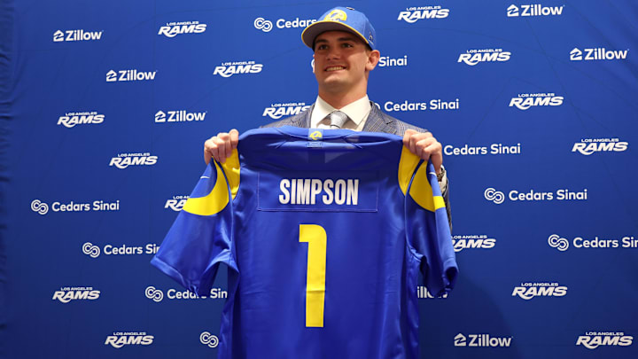 Los Angeles Rams first-round draft pick Ty Simpson poses with his jersey during a press conference at Code Next at Hollywood Park. Mandatory Credit: Kiyoshi Mio-Imagn Images