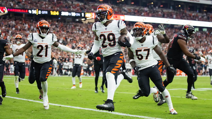 Oct 8, 2023; Glendale, Arizona, USA; Cincinnati Bengals cornerback Cam Taylor-Britt (29) returns an interception for a touchdown alongside linebacker Germaine Pratt (57) and cornerback Mike Hilton (21) against the Arizona Cardinals in the first half at State Farm Stadium. Mandatory Credit: Mark J. Rebilas-Imagn Images