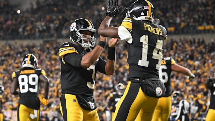 Oct 20, 2024; Pittsburgh, Pennsylvania, USA; Pittsburgh Steelers wide receiver George Pickens (14) celebrates an 11 yard touchdown pass with quarterback Russell Wilson (3) iagainst the New York Jets during the second quarter at Acrisure Stadium. Mandatory Credit: Barry Reeger-Imagn Images