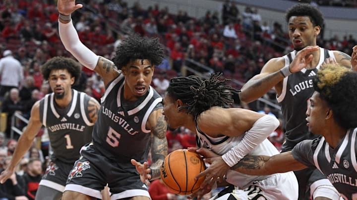 Jan 28, 2025; Louisville, Kentucky, USA; Louisville Cardinals guard Chucky Hepburn (24) and guard Terrence Edwards Jr. (5) try to strip the ball from Wake Forest Demon Deacons guard Hunter Sallis (23) during the first half at KFC Yum! Center. Jan 28, 2025; Louisville, Kentucky, USA; Louisville Cardinals guard Chucky Hepburn (24) and guard Terrence Edwards Jr. (5) try to strip the ball from Wake Forest Demon Deacons guard Hunter Sallis (23) during the first half at KFC Yum! Center.