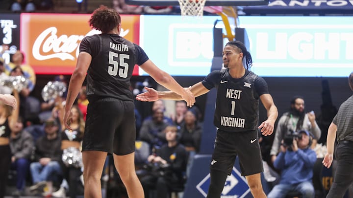 Feb 8, 2026; Morgantown, West Virginia, USA; West Virginia Mountaineers guard Jasper Floyd (1) celebrates with West Virginia Mountaineers center Harlan Obioha (55) during the second half against the Texas Tech Red Raiders at Hope Coliseum. Mandatory Credit: Ben Queen-Imagn Images