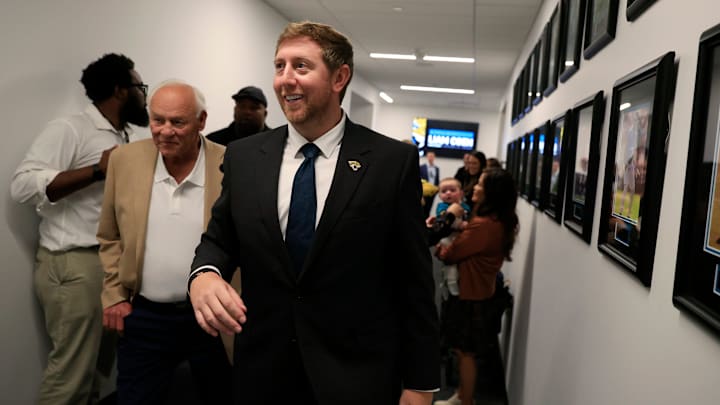 Liam Coen, center, walks with his father Tim Coen, left, as Edna Garcia, mother-in-law, right, holds son Callahan Coen, 7 months, after speaking and being introduced as the new Jacksonville Jaguars head cocah during a press conference Monday, Jan. 27, 2025 at the Miller Electric Center in Jacksonville, Fla. [Corey Perrine/Florida Times-Union]