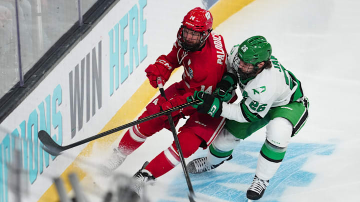 Apr 9, 2026; Las Vegas, Nevada, UNITED STATES; Wisconsin Badgers defenseman Joe Palodichuk (14) and North Dakota Fighting Hawks forward Dylan James (26) battle for the puck in the first period in the semifinals of the NCAA men's ice hockey Frozen Four at T-Mobile Arena. Mandatory Credit: Stephen R. Sylvanie-Imagn Images Apr 9, 2026; Las Vegas, Nevada, UNITED STATES; Wisconsin Badgers defenseman Joe Palodichuk (14) and North Dakota Fighting Hawks forward Dylan James (26) battle for the puck in the first period in the semifinals of the NCAA men's ice hockey Frozen Four at T-Mobile Arena. Mandatory Credit: Stephen R. Sylvanie-Imagn Images