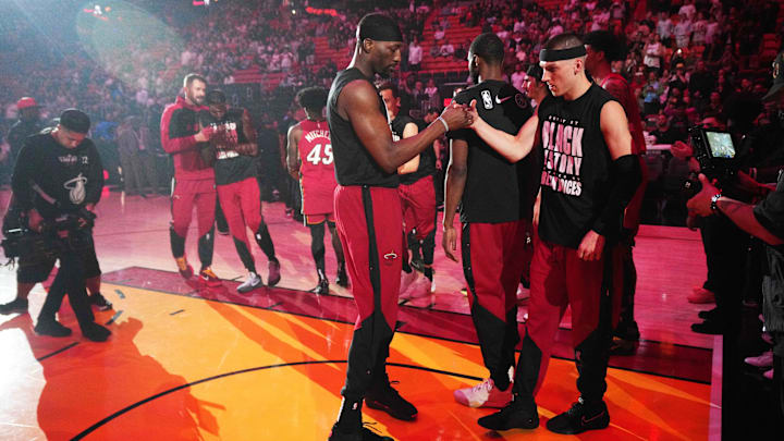 Feb 26, 2025; Miami, Florida, USA;  Miami Heat center Bam Adebayo, left, and guard Tyler Herro (14) greet each other during team introductions before the game against the Atlanta Hawks at Kaseya Center. Mandatory Credit: Jim Rassol-Imagn Images