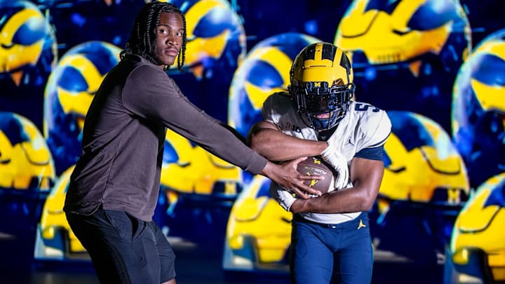 Michigan QB Bryce Underwood hands the ball off to top RB target Savion Hiter