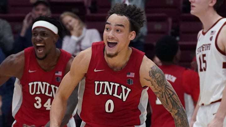  UNLV Runnin' Rebels guard Dra Gibbs-Lawhorn (0) and center Emmanuel Stephen (34) celebrate after the buzzer sounds as Stanford Cardinal forward/center Oskar Giltay (15) looks on in the second half at Maples Pavilion. Mandatory Credit: David Gonzales-Imagn Images