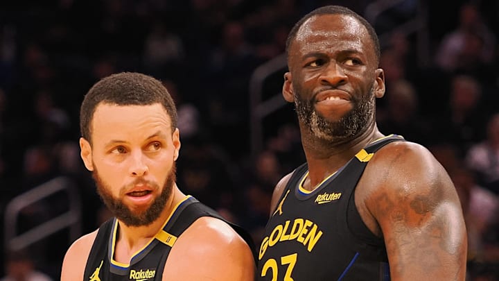Feb 3, 2025; San Francisco, California, USA; Golden State Warriors guard Stephen Curry (30) and forward Draymond Green (23) look towards an Orlando Magic player at half time at Chase Center. Mandatory Credit: Kelley L Cox-Imagn Images