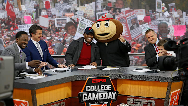 Lee Corso gives the thumbs up after picking Ohio State to win while, from left, Desmond Howard, Rece Davis, Archie Griffin, and Kirk Herbstreit sit on the set of ESPN's College GameDay broadcast from the campus of Ohio State prior to the NCAA football game against the Michigan State Spartans in Columbus on Nov. 21, 2015.