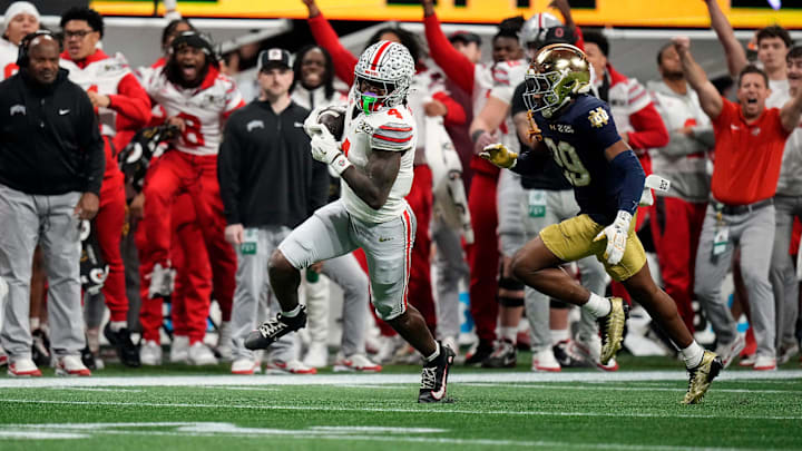 Ohio State Buckeyes wide receiver Jeremiah Smith (4) makes a catch against Notre Dame Fighting Irish cornerback Christian Gray (29) in the fourth quarter during the College Football Playoff National Championship at Mercedes-Benz Stadium in Atlanta on January 20, 2025.