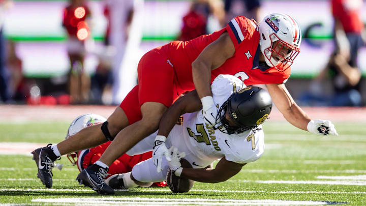 Oct 19, 2024; Tucson, Arizona, USA; Arizona Wildcats linebacker Taye Brown (6) tackles Colorado Buffalos running back Dallan Hayden (7) at Arizona Stadium. Mandatory Credit: Mark J. Rebilas-Imagn Images