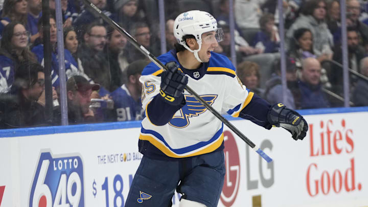 Oct 24, 2024; Toronto, Ontario, CAN; St. Louis Blues forward Jordan Kyrou (25) reacts after assisting on a goal by forward Alexandre Texier (not pictured) during the second period against the Toronto Maple Leafs at Scotiabank Arena. Mandatory Credit: John E. Sokolowski-Imagn Images