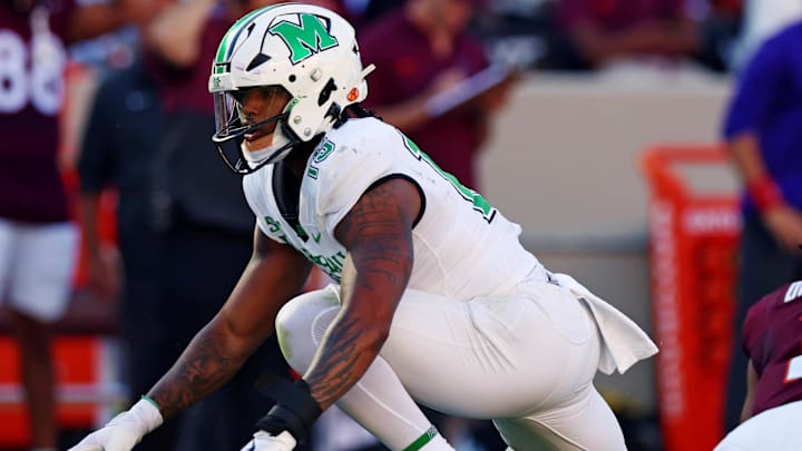 Sep 7, 2024; Blacksburg, Virginia, USA; Marshall Thundering Herd defensive lineman Mike Green (15) celebrates after sacking Virginia Tech Hokies quarterback Kyron Drones (1) during the first quarter at Lane Stadium. Mandatory Credit: Peter Casey-Imagn Images