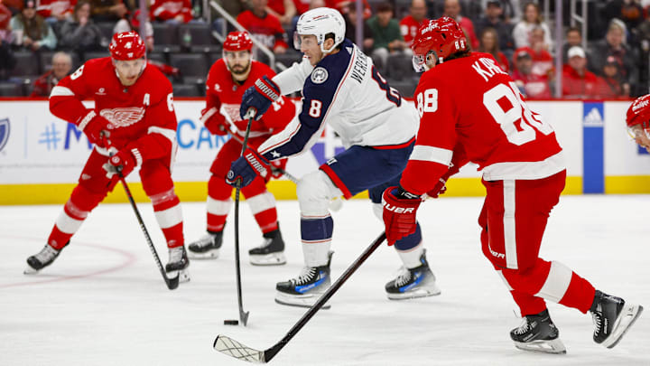 Mar 19, 2024; Detroit, Michigan, USA; Columbus Blue Jackets defenseman Zach Werenski (8) shoots the puck during the first period of the game against the Detroit Red Wings at Little Caesars Arena. Mandatory Credit: Brian Bradshaw Sevald-Imagn Images