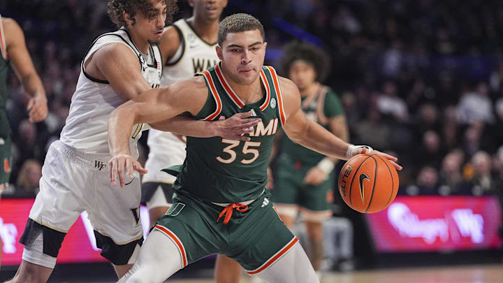 Jan 7, 2026; Winston-Salem, North Carolina, USA; Miami (FL) Hurricanes guard Dante Allen (35) handles the ball against Wake Forest Demon Deacons guard Nate Calmese (1) during the second half at Lawrence Joel Veterans Memorial Coliseum. Mandatory Credit: Jim Dedmon-Imagn Images