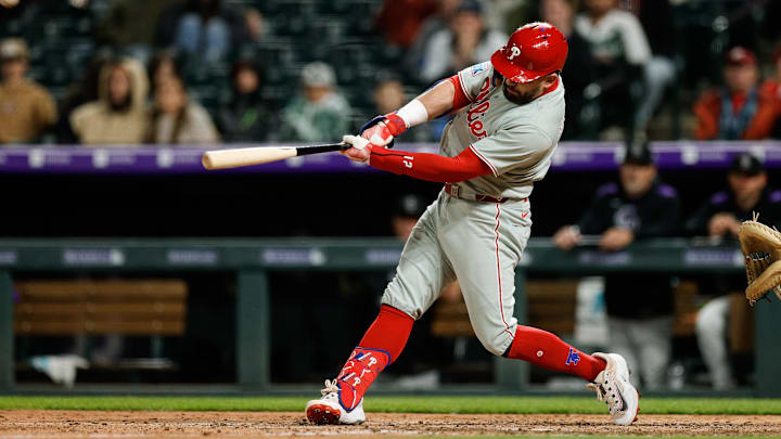  Philadelphia Phillies designated hitter Kyle Schwarber (12) hits a solo home run in the ninth inning against the Colorado Rockies at Coors Field. 