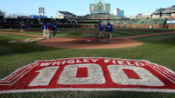 Apr 22, 2014; Chicago, IL, USA; A general view of a 100-year anniversary logo painted on the field as grounds crew members prepare the field before the game between the Chicago Cubs and Arizona Diamondbacks at Wrigley Field. Apr 22, 2014; Chicago, IL, USA; A general view of a 100-year anniversary logo painted on the field as grounds crew members prepare the field before the game between the Chicago Cubs and Arizona Diamondbacks at Wrigley Field.