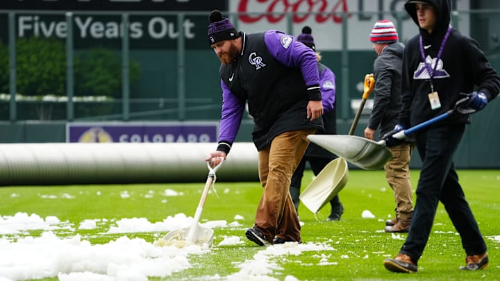 May 21, 2022; Denver, Colorado, USA; General view as a Colorado Rockies ground crew members clear snow before the game against the New York Mets at Coors Field. Mandatory Credit: Ron Chenoy-Imagn Images