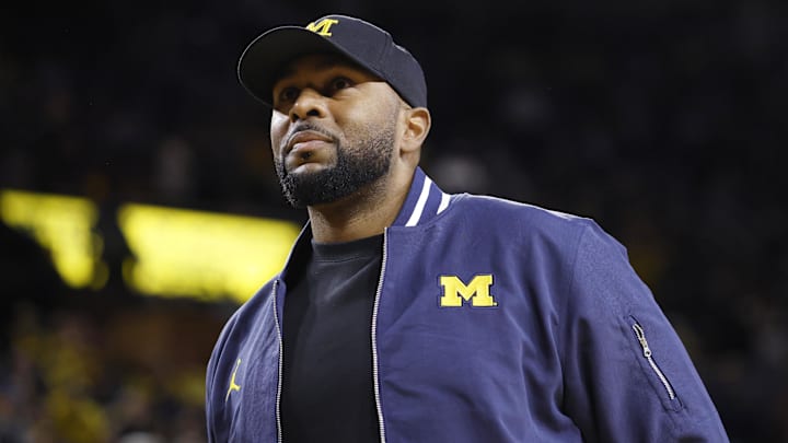 Jan 19, 2025; Ann Arbor, Michigan, USA;  Michigan Wolverines head football coach Sherrone Moore fires up the crowd in overtime of the basketball game against the Northwestern Wildcats at Crisler Center. Mandatory Credit: Rick Osentoski-Imagn Images