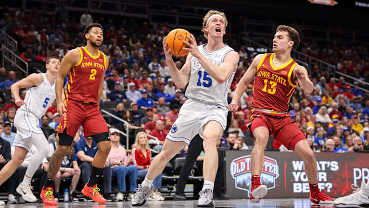 Mar 13, 2025; Kansas City, MO, USA; Brigham Young Cougars forward Richie Saunders (15) drives to the basket around Iowa State Cyclones guard Cade Kelderman (13) during the first half at T-Mobile Center. Mandatory Credit: William Purnell-Imagn Images