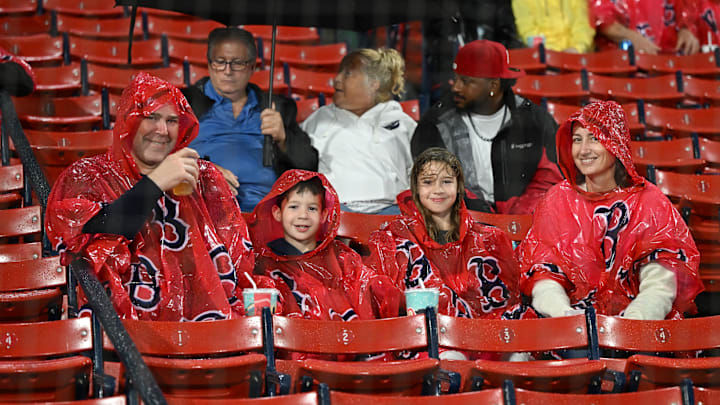 Sep 11, 2023; Boston, Massachusetts, USA; Fans sit through a rain delay before a game between the New York Yankees and the Boston Red Sox at Fenway Park. Mandatory Credit: Brian Fluharty-USA TODAY Sports
