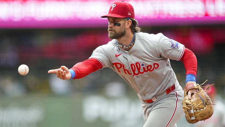 Jun 14, 2026; Milwaukee, Wisconsin, USA; Philadelphia Phillies first baseman Bryce Harper (3) tosses the ball towards first base during the sixth inning against the Milwaukee Brewers at American Family Field. Jun 14, 2026; Milwaukee, Wisconsin, USA; Philadelphia Phillies first baseman Bryce Harper (3) tosses the ball towards first base during the sixth inning against the Milwaukee Brewers at American Family Field.