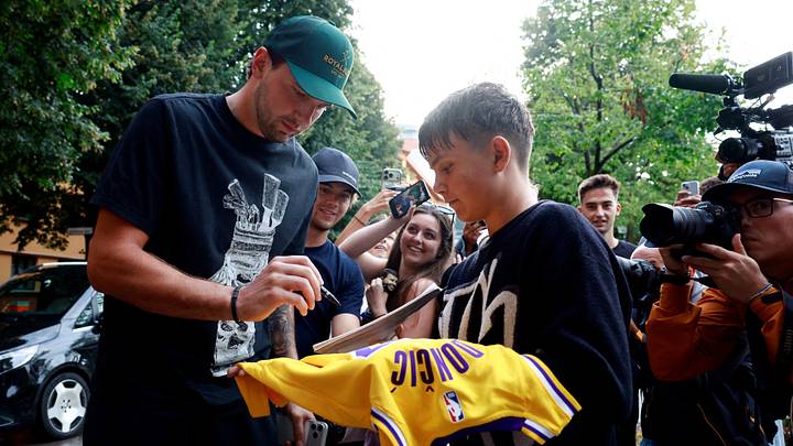 Los Angeles Lakers' Luka Doncic signs jerseys for fans as the team visits Ljubljana for a camp.