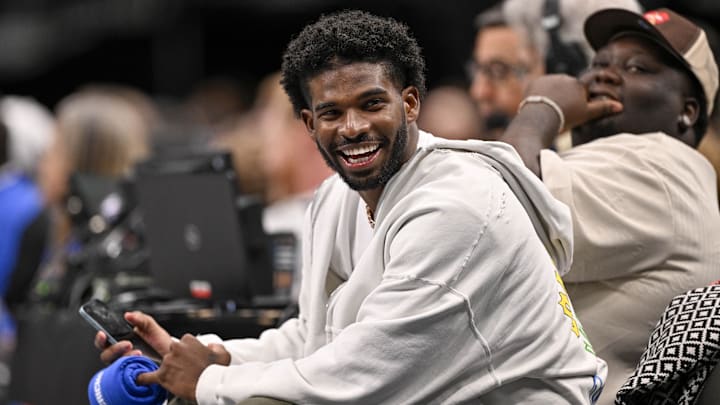 Jan 14, 2025; Dallas, Texas, USA; Colorado Buffaloes quarterback Shedeur Sanders laughs as he watches the game between the Dallas Mavericks and the Denver Nuggets during the second half at the American Airlines Center. Mandatory Credit: Jerome Miron-Imagn Images Jan 14, 2025; Dallas, Texas, USA; Colorado Buffaloes quarterback Shedeur Sanders laughs as he watches the game between the Dallas Mavericks and the Denver Nuggets during the second half at the American Airlines Center. Mandatory Credit: Jerome Miron-Imagn Images