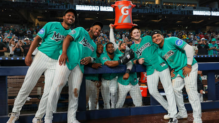 Miami Marlins right fielder Owen Caissie (17) poses for a photo with pitcher Michael Petersen (49), first baseman Deyvison de Los Santos (63), second baseman Xavier Edwards (9), shortstop Otto Lopez (6), catcher Agustin Ramirez (50), and third baseman Javier Sanoja (8) after hitting a two-run walk-off home run against the Colorado Rockies during the ninth inning at loanDepot Park. 