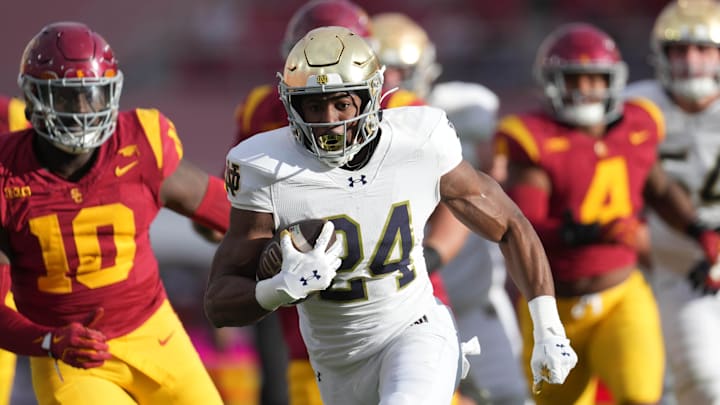 Nov 30, 2024; Los Angeles, California, USA; Notre Dame Fighting Irish running back Jadarian Price (24) scores on a 36-yard touchdown run against the Southern California Trojans in the second half at United Airlines Field at Los Angeles Memorial Coliseum. Mandatory Credit: Kirby Lee-Imagn Images Nov 30, 2024; Los Angeles, California, USA; Notre Dame Fighting Irish running back Jadarian Price (24) scores on a 36-yard touchdown run against the Southern California Trojans in the second half at United Airlines Field at Los Angeles Memorial Coliseum. Mandatory Credit: Kirby Lee-Imagn Images