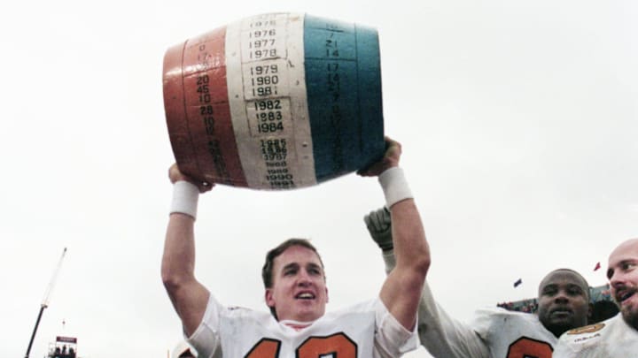 Tennessee quarterback Peyton Manning (16) lifts the beer barrel, which annually goes to the winner of the Vols-Kentucky SEC battle. The 5th-ranked Vols defeated the Wildcats 59-31 at Commonwealth Stadium in Lexington, Ky., Nov. 22, 1997.