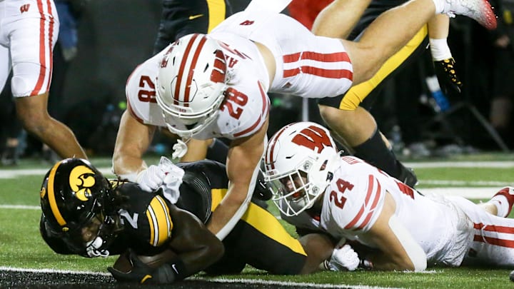 Iowa running back Kaleb Johnson (2) scores a touchdown as Wisconsin’s linebacker Christian Alliegro (28) and safety Hunter Wohler (24) defend Saturday, Nov. 2, 2024 at Kinnick Stadium in Iowa City, Iowa.