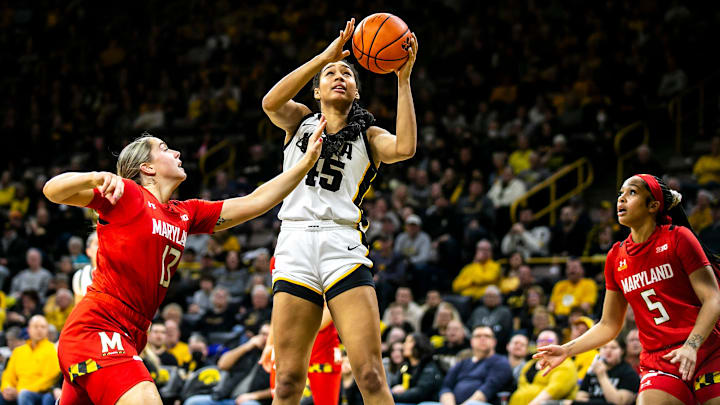Iowa forward Hannah Stuelke, center, shoots the ball as Maryland's Faith Masonius, left, and Brinae Alexander defend during a NCAA Big Ten Conference women's basketball game, Thursday, Feb. 2, 2023, at Carver-Hawkeye Arena in Iowa City, Iowa.
