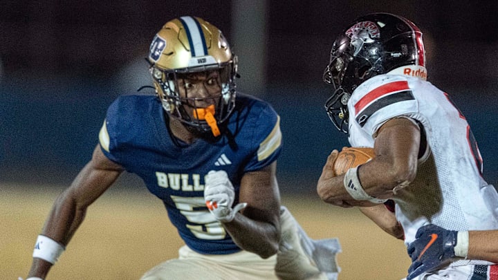 West Boca's Jaydin Broadnax, left, cuts off Southridge running back Shandon Smith as Maxwell Reid, tackles him during their state semifinal game on December 6, 2024, in Boca Raton, Florida. West Boca's Jaydin Broadnax, left, cuts off Southridge running back Shandon Smith as Maxwell Reid, tackles him during their state semifinal game on December 6, 2024, in Boca Raton, Florida.
