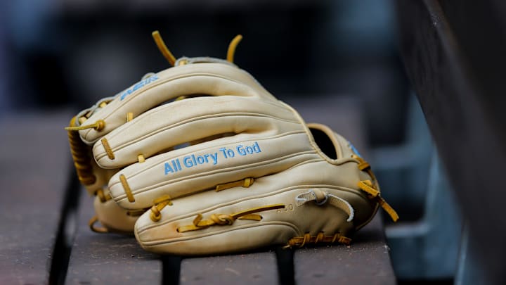 A Minnesota Twins glove sits on the bench before the MLB Interleague game between the Cincinnati Reds.