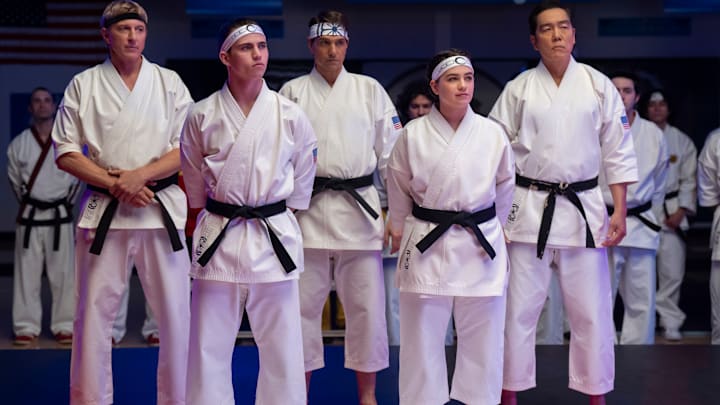 Cobra Kai. (L to R) William Zabka as Johnny Lawrence, Tanner Buchanan as Robby Keene, Ralph Macchio as Daniel LaRusso, Mary Mouser as Samantha LaRusso, Yuji Okumoto as Chozen in Cobra Kai. Cr. Curtis Bonds Baker/Netflix © 2024