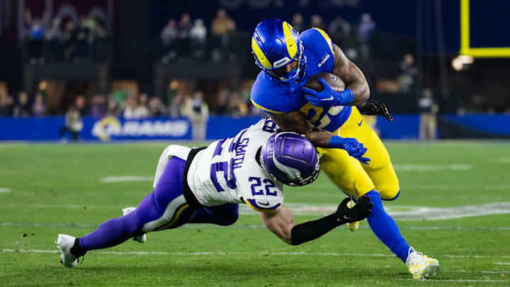 Jan 13, 2025; Glendale, AZ, USA; Los Angeles Rams running back Kyren Williams (23) is tackled by Minnesota Vikings safety Harrison Smith (22) during an NFC wild card game at State Farm Stadium.