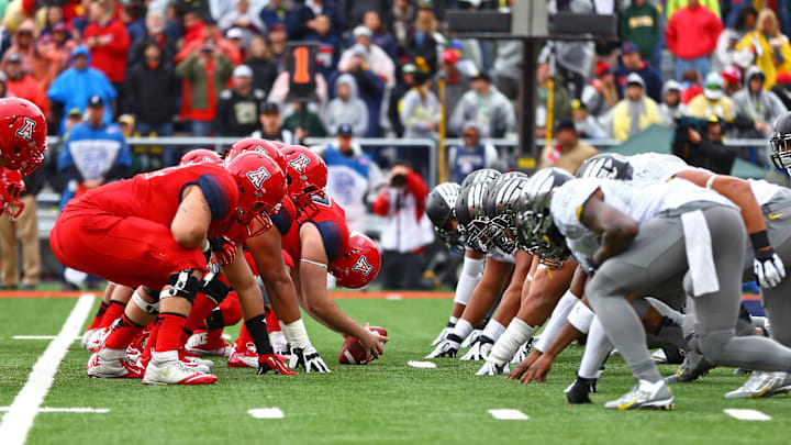 Nov 23, 2013; Tucson, AZ, USA; The Arizona Wildcats offensive lines up on the line of scrimmage preparing to snap the ball against the Oregon Ducks at Arizona Stadium. Arizona defeated Oregon 42-16. Mandatory Credit: Mark J. Rebilas-Imagn Images