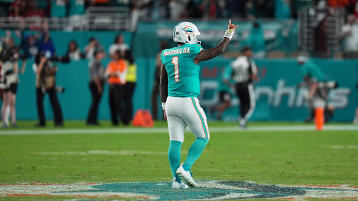 Dec 22, 2024; Miami Gardens, Florida, USA; Miami Dolphins quarterback Tua Tagovailoa (1) celebrates the touchdown of running back De'Von Achane (28, not pictured) during second half against the San Francisco 49ers at Hard Rock Stadium. Mandatory Credit: Jasen Vinlove-Imagn Images