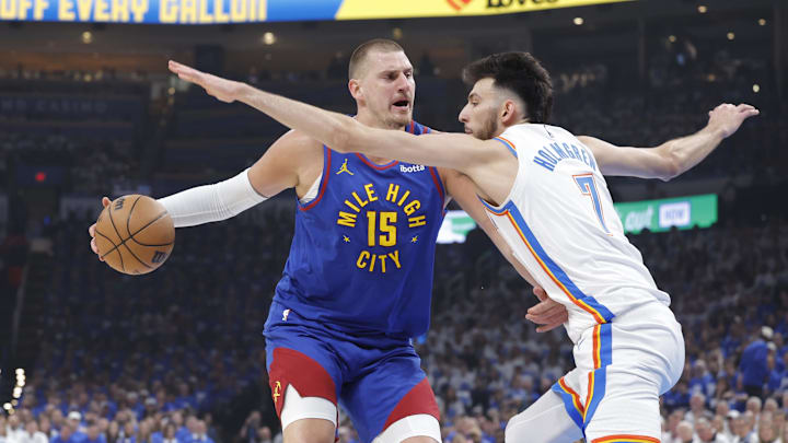 May 13, 2025; Oklahoma City, Oklahoma, USA; Denver Nuggets center Nikola Jokic (15) is defended by Oklahoma City Thunder forward Chet Holmgren (7) on a drive during the first quarter of game five of the second round for the 2025 NBA Playoffs at Paycom Center. Mandatory Credit: Alonzo Adams-Imagn Images