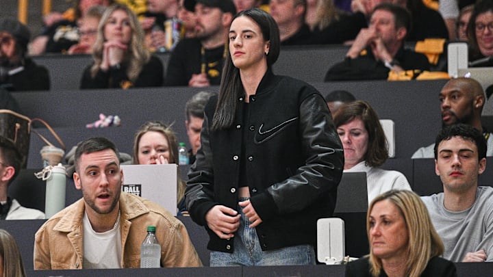 Feb 2, 2025; Iowa City, Iowa, USA; Former Iowa Hawkeyes player Caitlin Clark (center) looks on during the game between the Iowa Hawkeyes and the USC Trojans at Carver-Hawkeye Arena. Mandatory Credit: Jeffrey Becker-Imagn Images